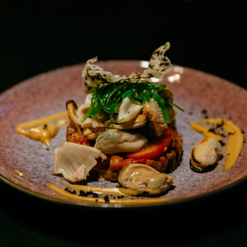 Plate of seafood salad with sauce. Modern presentation. Restaurant food.